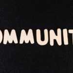 the word community written in white on a black background