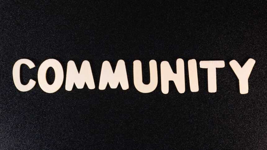 the word community written in white on a black background