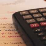 a calculator sitting on top of a piece of paper