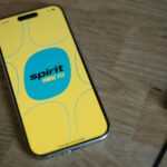 A cell phone sitting on top of a wooden table