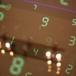 Numbers are reflected on a surface, blurring the image.