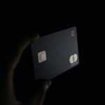 person holding black card