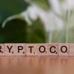 A wooden block spelling crypt on a table