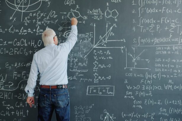 A professor writing complex formulas on a blackboard.