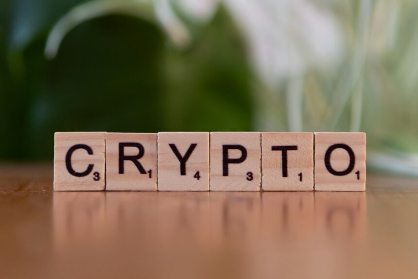 A wooden block spelling crypt on a table