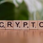 A wooden block spelling crypt on a table