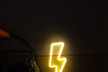 a neon sign that is on the side of a wall