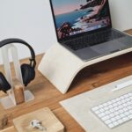 a laptop computer sitting on top of a wooden desk