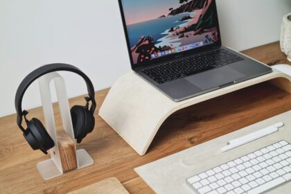 a laptop computer sitting on top of a wooden desk