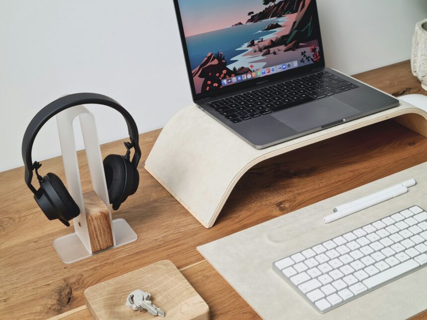 a laptop computer sitting on top of a wooden desk