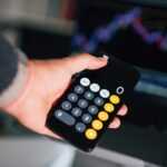 a person holding a remote control in their hand